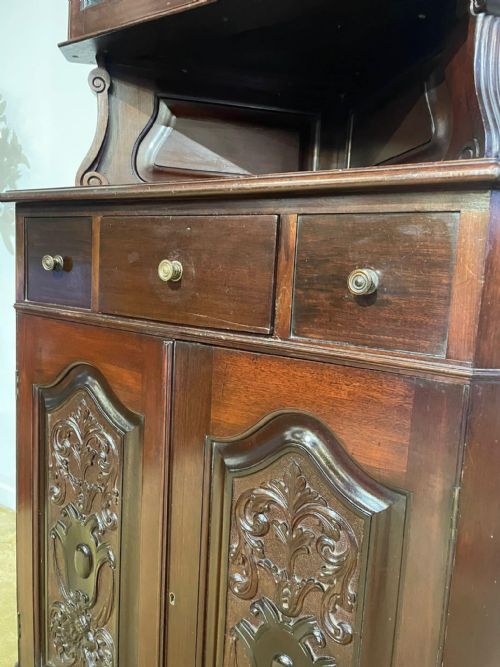 fig 3. A tall, dark mahogany late 19th-century corner cupboard featuring a glazed upper display cabinet, an open central gallery, and carved lower panel doors.