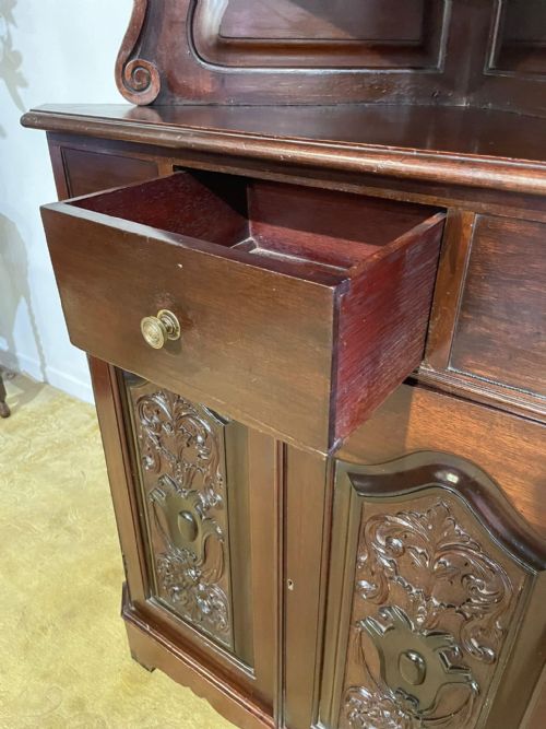 fig 5. A tall, dark mahogany late 19th-century corner cupboard featuring a glazed upper display cabinet, an open central gallery, and carved lower panel doors.