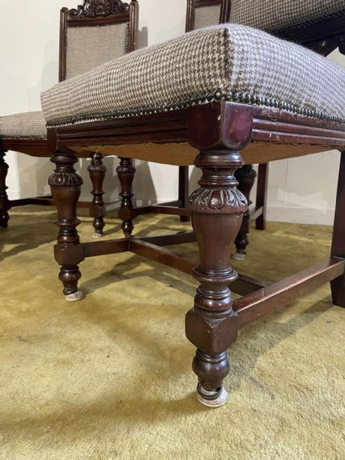 fig 1. A set of four dark timber Victorian dining chairs featuring carved shell crests, turned front legs, and patterned houndstooth fabric upholstery.