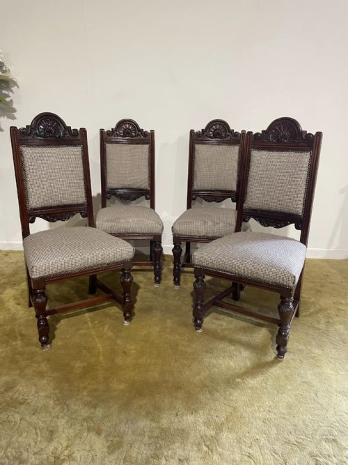 fig 3. A set of four dark timber Victorian dining chairs featuring carved shell crests, turned front legs, and patterned houndstooth fabric upholstery.