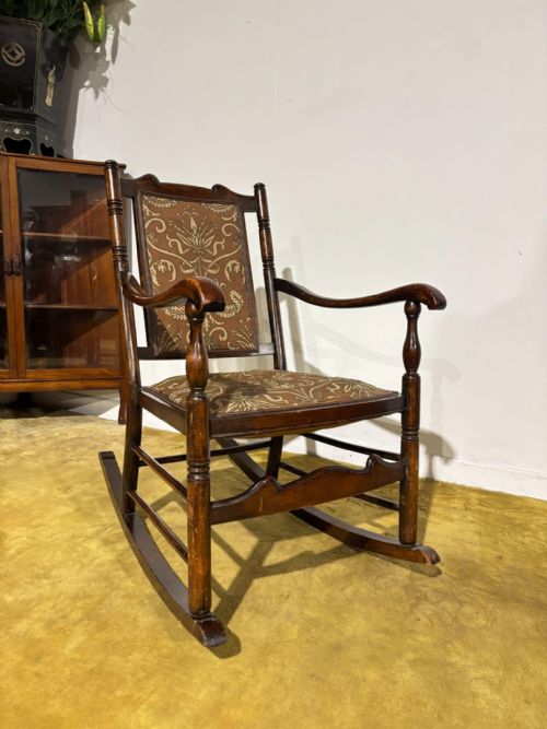 Vintage wooden rocking chair having an upholstered seat