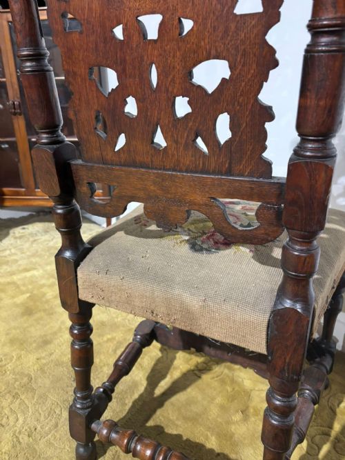 fig 6. A Carolean carved oak high back side chair featuring an intricately carved foliage cresting, turned supports, and a floral needlepoint seat.