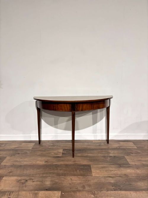 Antique mahogany inlaid D end table, set on tapered supports. 