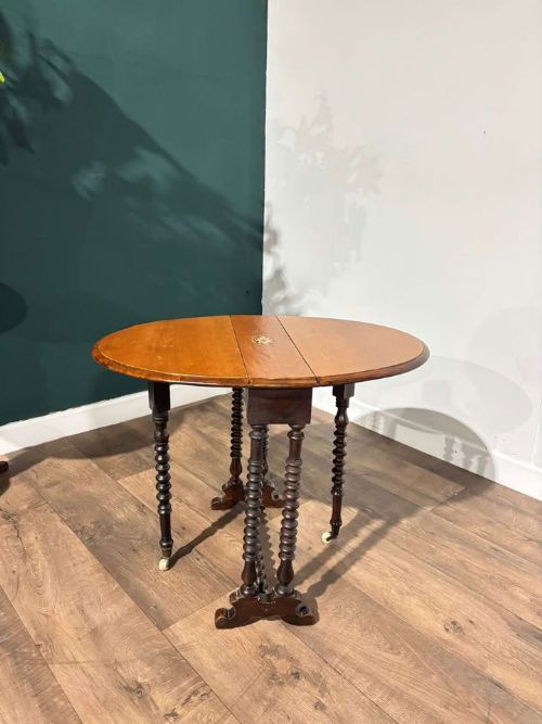 Late 19th century small Sutherland table, drop leaves, bobbin twist supports and a barley twist stretcher. 