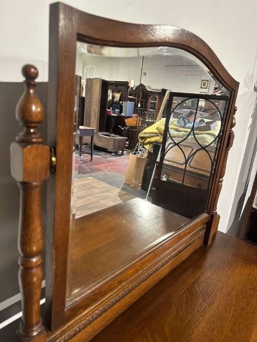 fig 5. A vintage oak dressing table with three long drawers, drop handles, turned legs, and an attached pivoting mirror.
