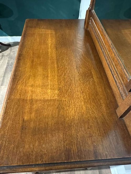 fig 7. A vintage oak dressing table with three long drawers, drop handles, turned legs, and an attached pivoting mirror.