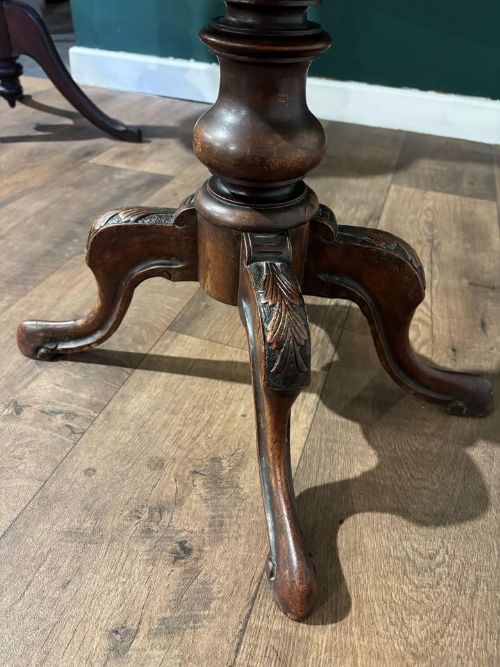 fig 2. A 19th-century Victorian walnut trumpet sewing table with fretwork side panels, a hinged top lid, turned pedestal, and carved tripod cabriole legs.