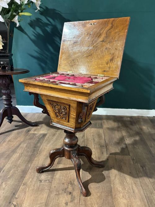 fig 3. A 19th-century Victorian walnut trumpet sewing table with fretwork side panels, a hinged top lid, turned pedestal, and carved tripod cabriole legs.