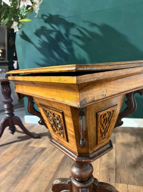 fig 5. A 19th-century Victorian walnut trumpet sewing table with fretwork side panels, a hinged top lid, turned pedestal, and carved tripod cabriole legs.