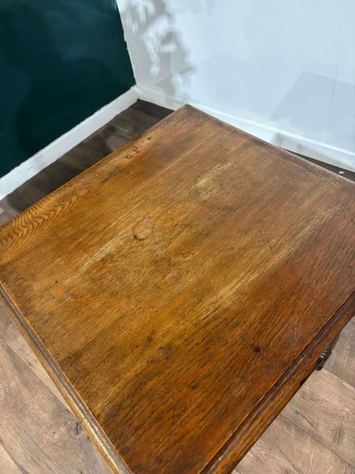 fig 7. A square dark oak window table featuring distinct turned legs with central bulbous knops and a lower perimeter box stretcher.