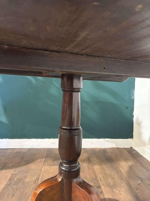 fig 1. A nineteenth-century mahogany tripod table featuring a circular polished top on a turned pedestal column with three splayed cabriole legs.