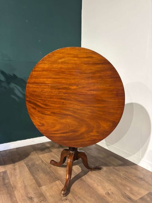fig 2. A nineteenth-century mahogany tripod table featuring a circular polished top on a turned pedestal column with three splayed cabriole legs.