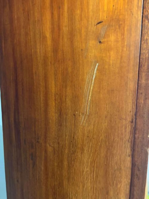 fig 3. An Edwardian walnut double wardrobe featuring two full-length oval mirrored doors flanking an inlaid central panel above a wide base drawer.