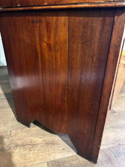fig 5. An Edwardian walnut double wardrobe featuring two full-length oval mirrored doors flanking an inlaid central panel above a wide base drawer.
