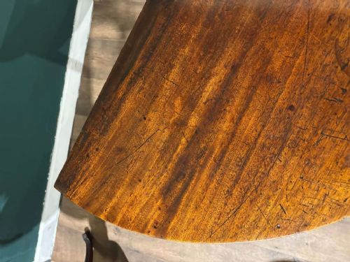 fig 6. A semi-circular antique mahogany D-end table with four square tapered legs and a polished timber top.