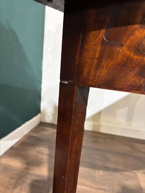 fig 7. A semi-circular antique mahogany D-end table with four square tapered legs and a polished timber top.