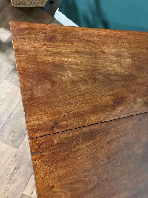 fig 8. An antique Georgian dark mahogany drop-leaf table shown standing fully extended on straight moulded legs.