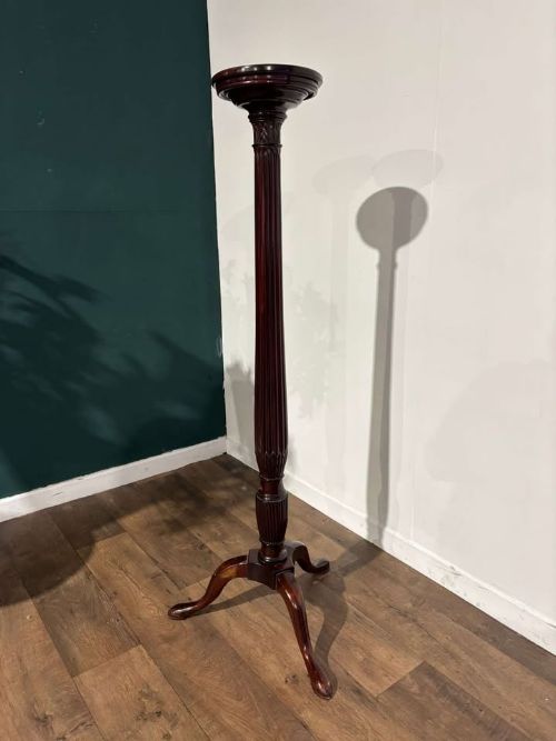 fig 5. A tall mahogany torchere plant stand featuring a circular dished top, a fluted column, and a tripod pedestal base.