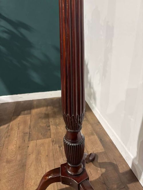 fig 7. A tall mahogany torchere plant stand featuring a circular dished top, a fluted column, and a tripod pedestal base.