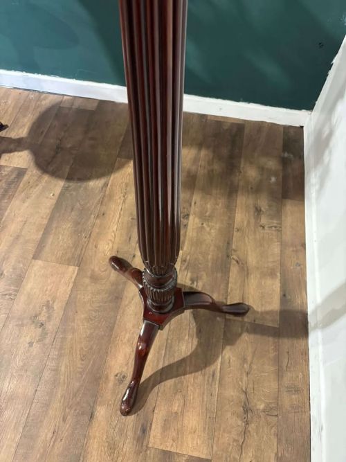 fig 8. A tall mahogany torchere plant stand featuring a circular dished top, a fluted column, and a tripod pedestal base.