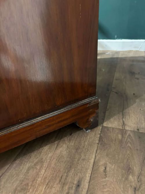 fig 9. An Edwardian inlaid mahogany bureau bookcase featuring upper geometric glazed doors above a slant-front drop-down desk and lower cupboards.