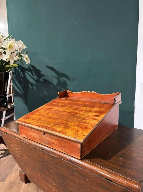 fig 5. A Victorian pine tabletop clerks desk with a sloped hinged lid, keyhole, and a carved gallery edge across the top.