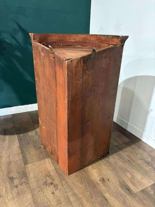 fig 9. A bow-fronted dark mahogany corner wall cupboard featuring twin doors with brass H-hinges and two drawers at the base.