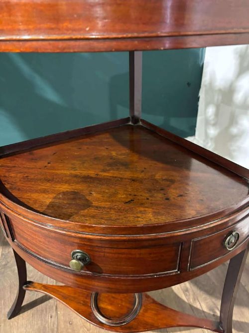 fig 2. A Georgian mahogany corner washstand featuring a tiered design with a shaped splashback, central bowfront drawer, and curved lower stretcher.
