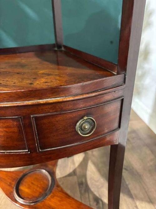 fig 3. A Georgian mahogany corner washstand featuring a tiered design with a shaped splashback, central bowfront drawer, and curved lower stretcher.