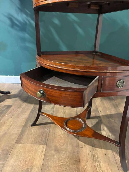 fig 4. A Georgian mahogany corner washstand featuring a tiered design with a shaped splashback, central bowfront drawer, and curved lower stretcher.