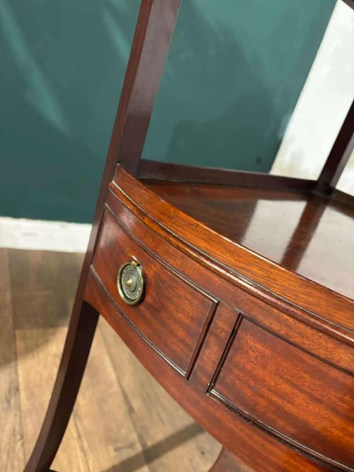 fig 5. A Georgian mahogany corner washstand featuring a tiered design with a shaped splashback, central bowfront drawer, and curved lower stretcher.