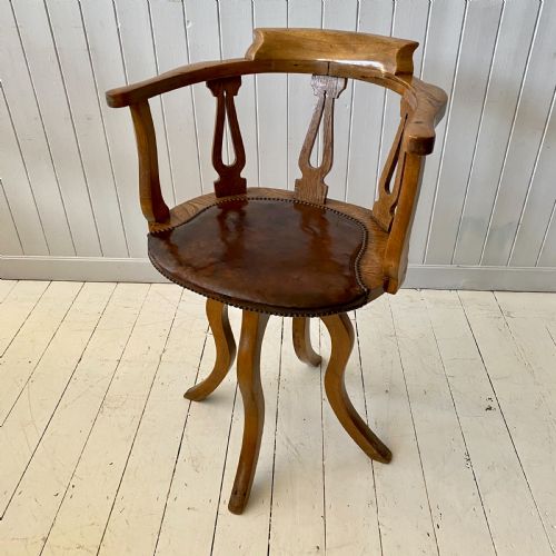 An Elm and Leather Swivel Desk Chair