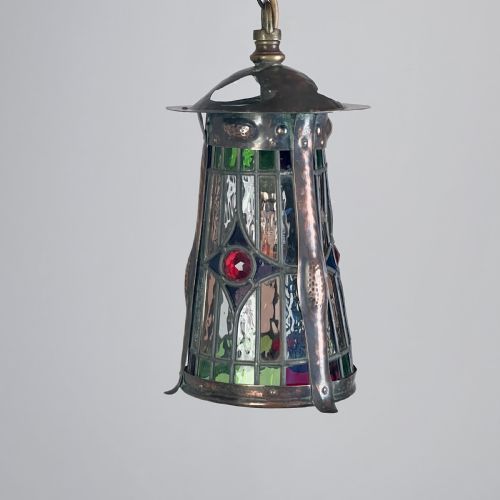 An Arts and Crafts Patinated Copper and Leaded Glass Hall Lantern