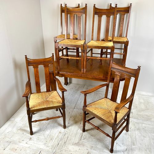 An Arts & Crafts Extending Oak Dining Table & Six Chairs
