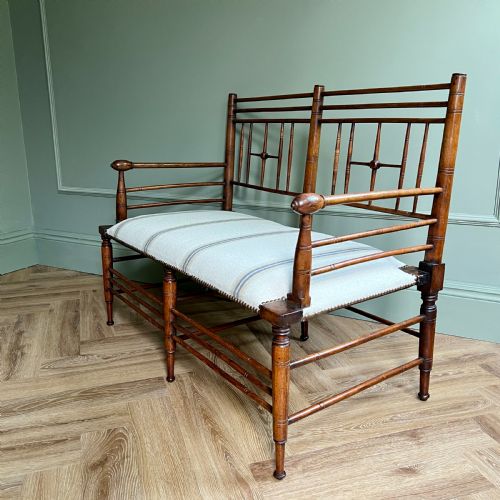 A Rare Walnut Two Seater Argyle Settee by Liberty & Co. London