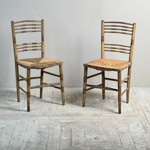 A PAIR OF PAINTED REGENCY FAUX BAMBOO AND RUSH SEAT CHAIRS