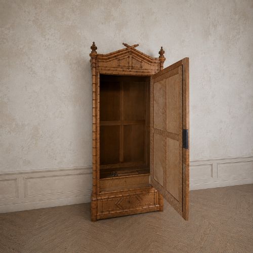 fig 2. French birds eye maple single door armoire featuring faux bamboo turned mouldings, a full-length mirrored panel, base drawer, and carved cresting.