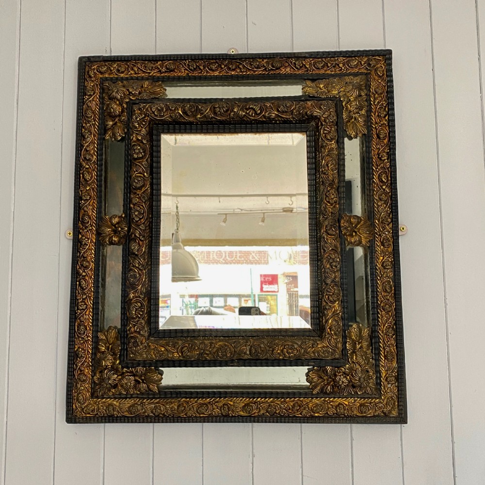 A Repousse Brass and Ebonised Cushion Mirror View II