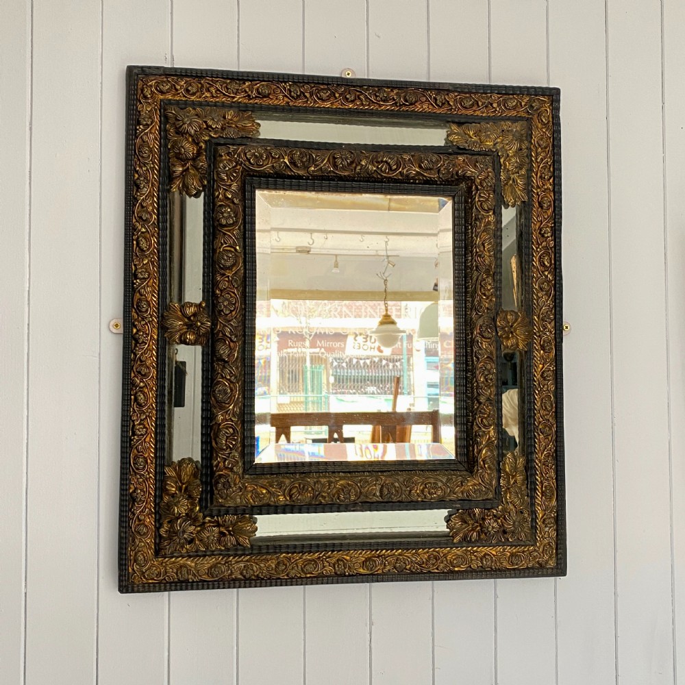 A Repousse Brass and Ebonised Cushion Mirror View III