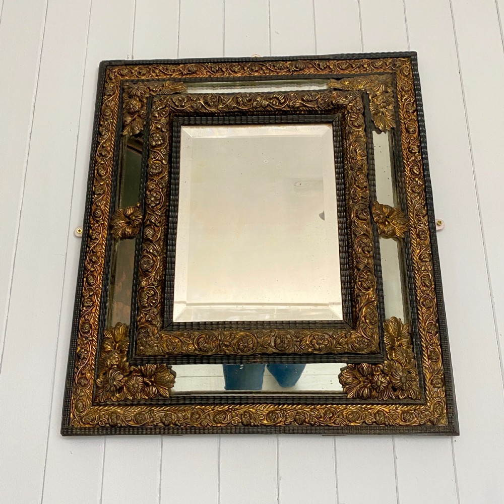 A Repousse Brass and Ebonised Cushion Mirror View V