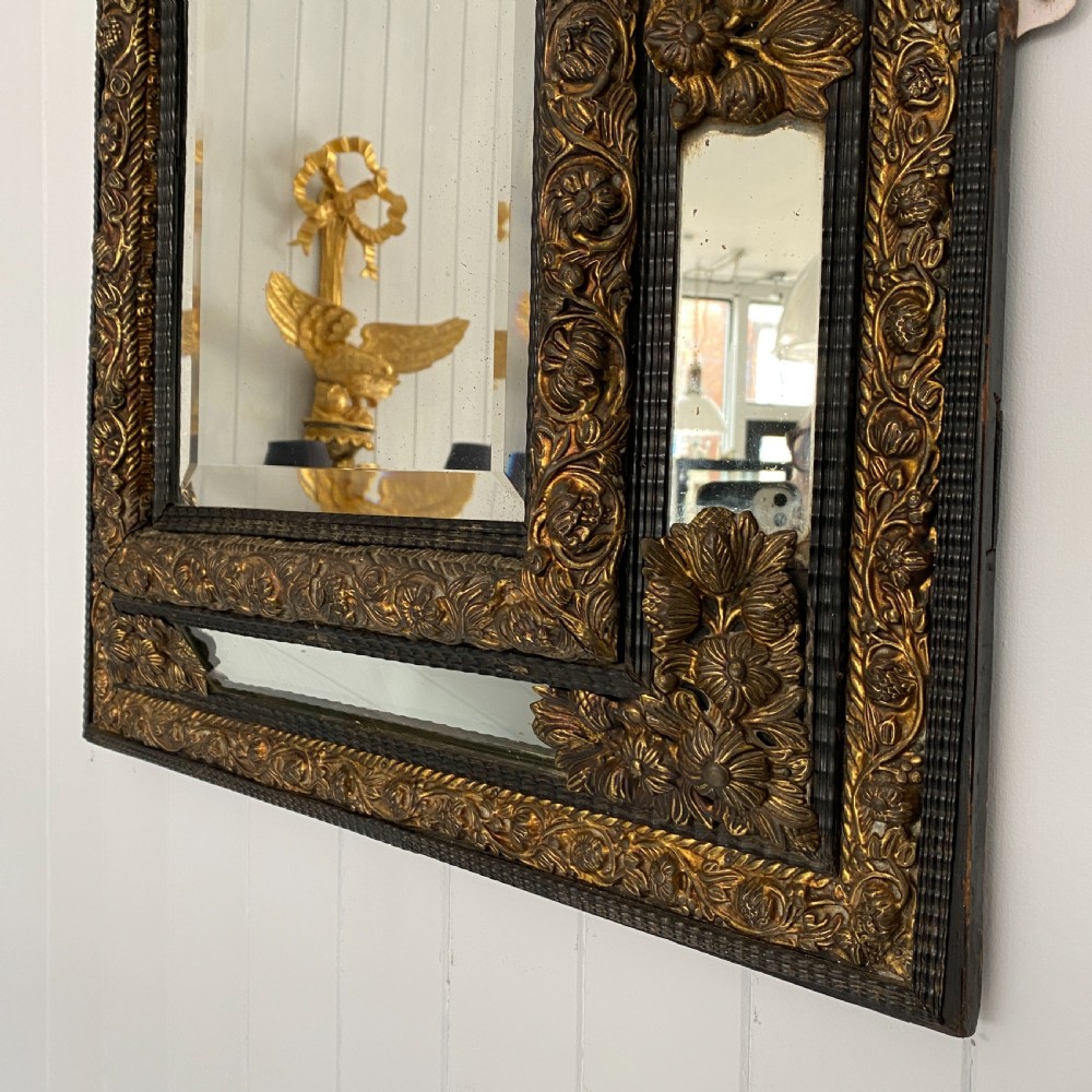 A Repousse Brass and Ebonised Cushion Mirror View VI