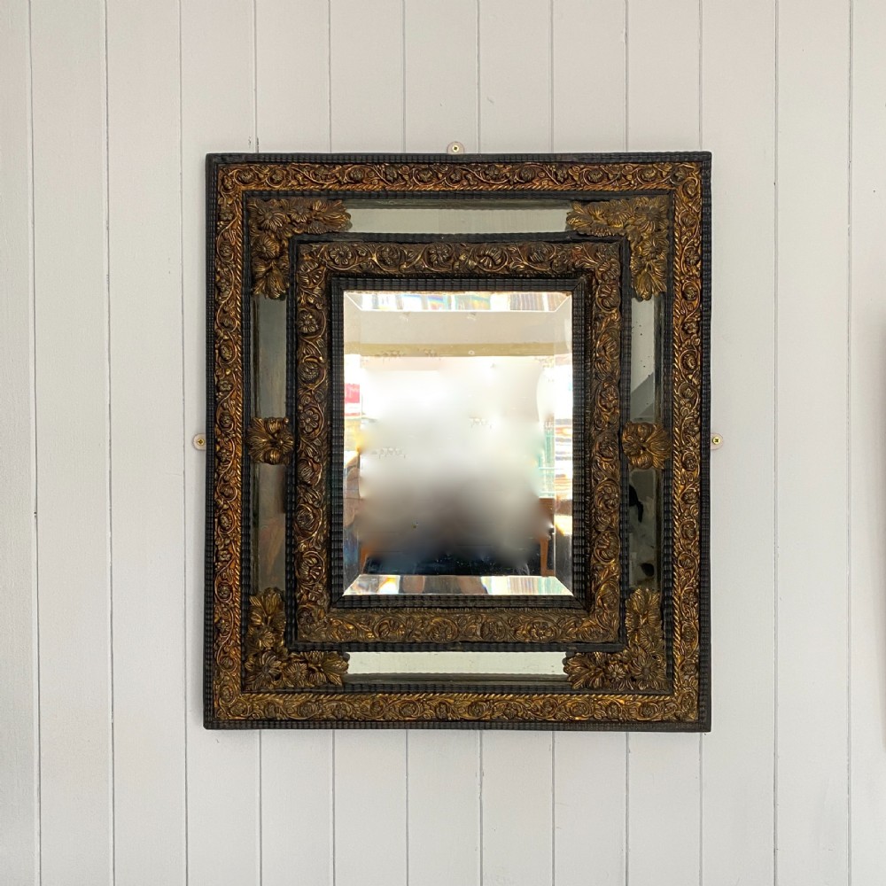 A Repousse Brass and Ebonised Cushion Mirror View VII