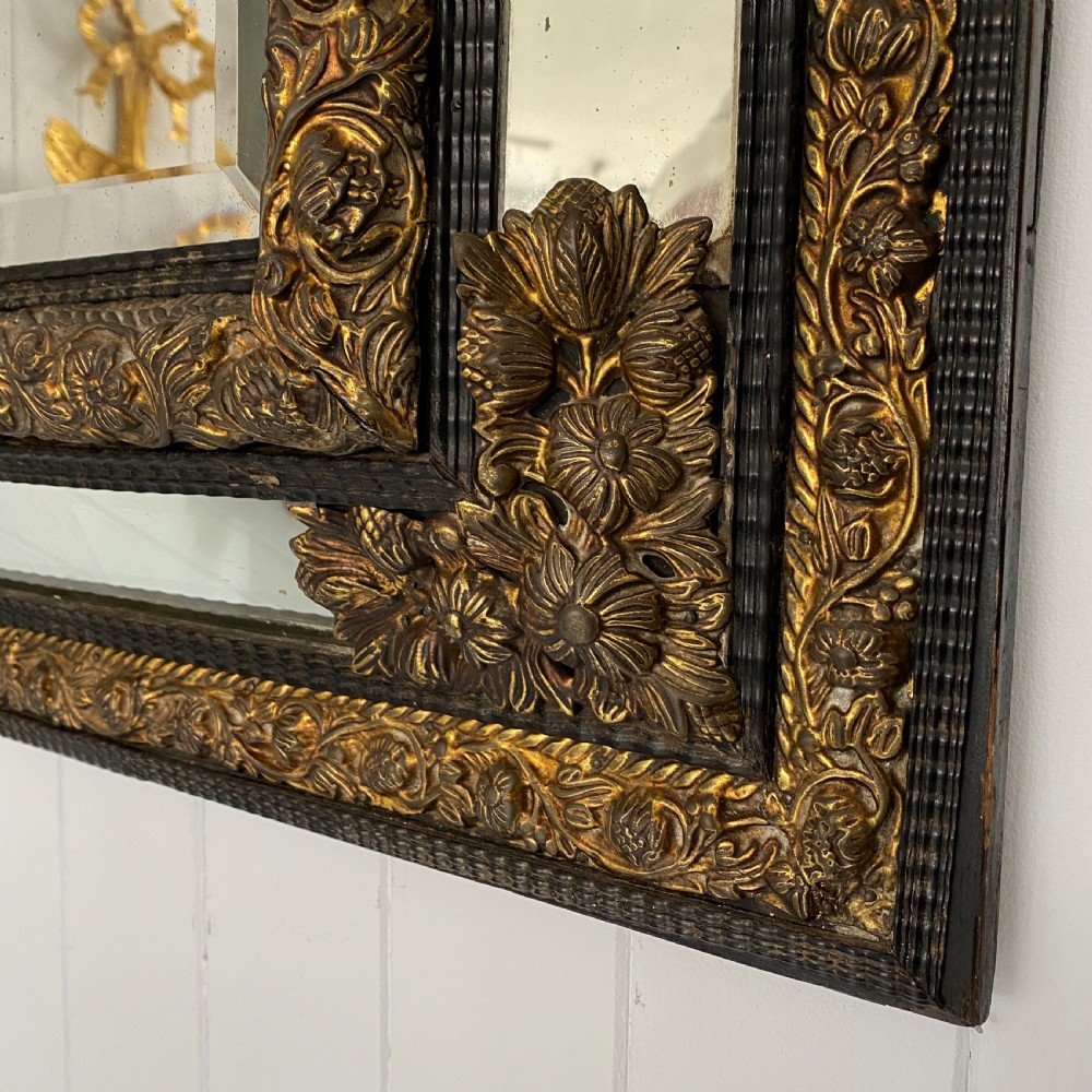 A Repousse Brass and Ebonised Cushion Mirror View VIII