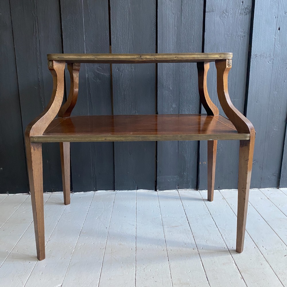 A two-tiered mahogany side table featuring a pink-veined marble top framed in brass, supported by curved legs over a lower wood shelf with brass side handles. View III