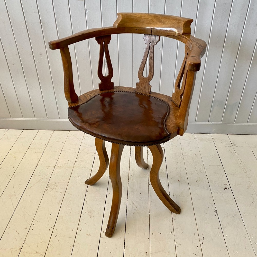 An Elm and Leather Swivel Desk Chair 