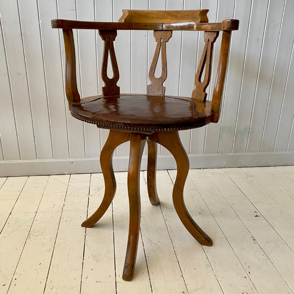 An Elm and Leather Swivel Desk Chair  View III
