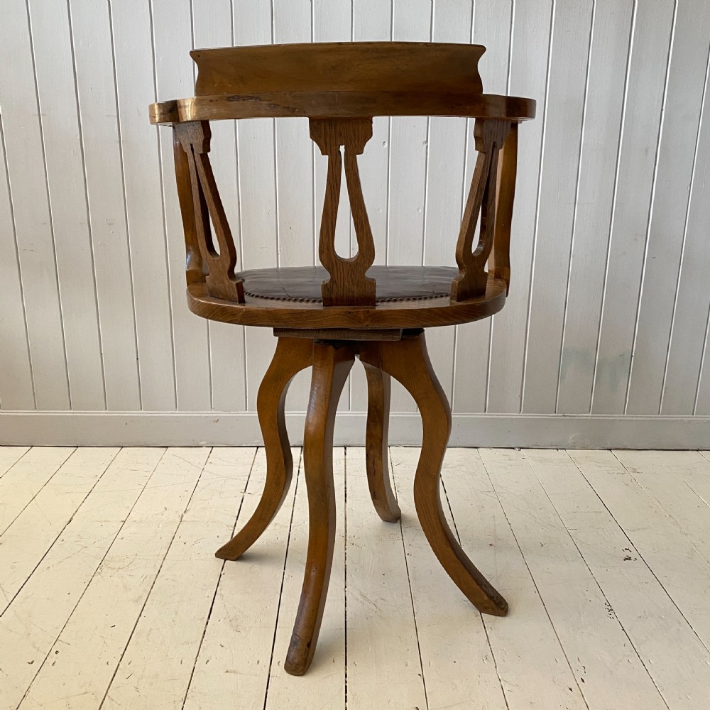 An Elm and Leather Swivel Desk Chair  View V