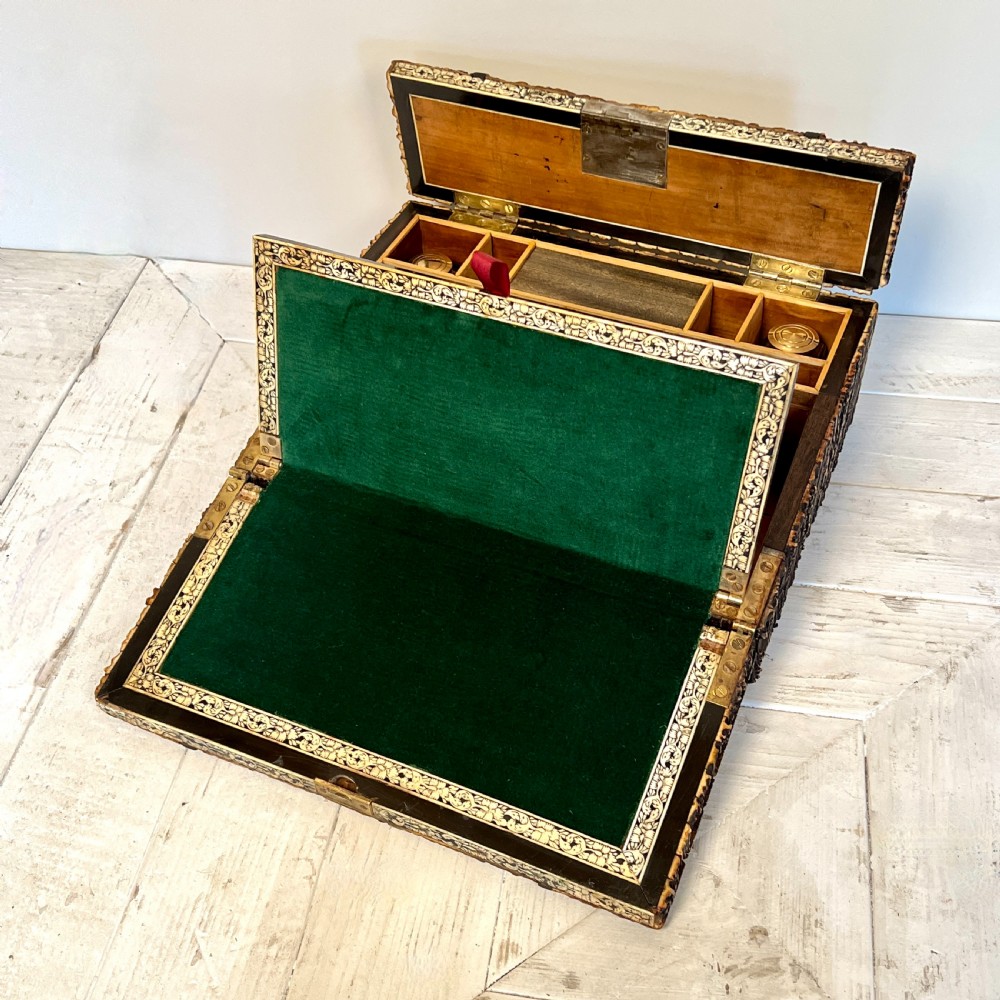 An open nineteenth-century Anglo-Indian writing slope displaying carved antler borders, floral bone inlay, and a green velvet writing surface.