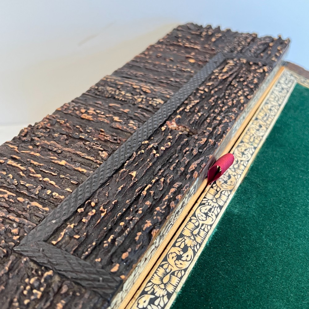 An open nineteenth-century Anglo-Indian writing slope displaying carved antler borders, floral bone inlay, and a green velvet writing surface. View VII