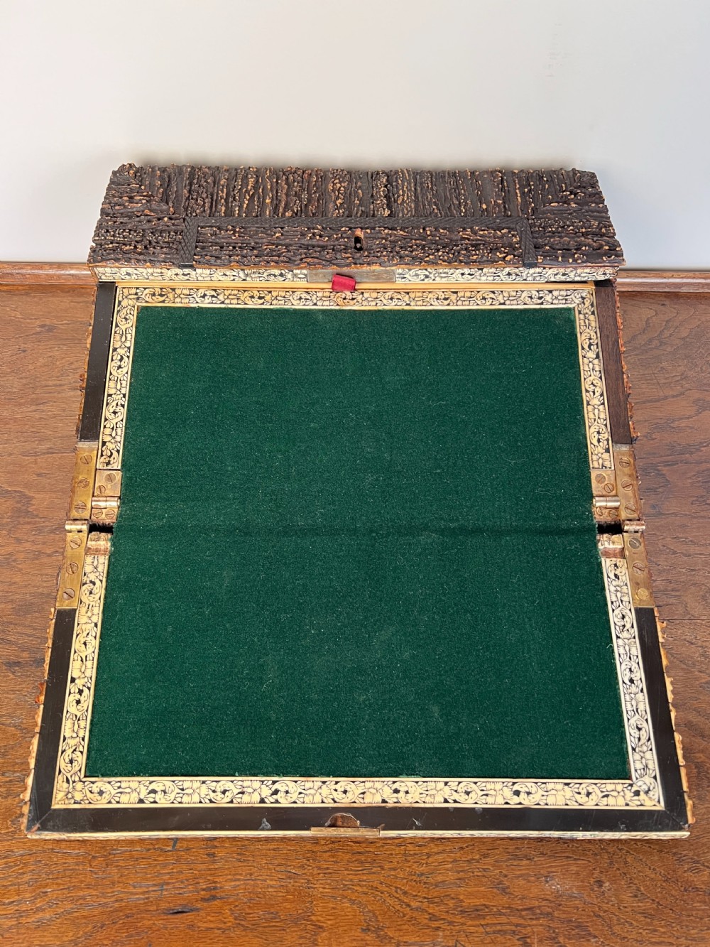 An open nineteenth-century Anglo-Indian writing slope displaying carved antler borders, floral bone inlay, and a green velvet writing surface. View IX